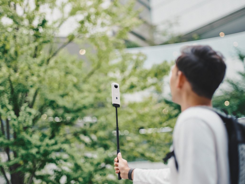 The Ricoh Theta SC2 being used with a monopod